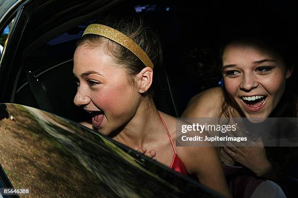 teenage girls looking out of limo window - prom stockfoto's en -beelden