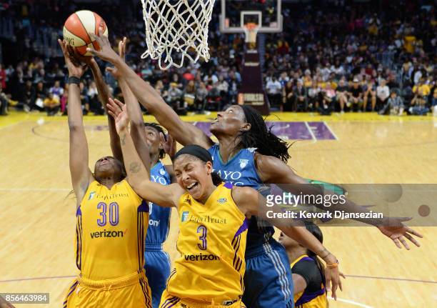 Candace Parker forward Nneka Ogwumike of the Los Angeles Sparks battle for a rebound against center Sylvia Fowles of the Minnesota Lynxs during the...