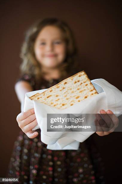 girl holding matzoh - passover symbols stock-fotos und bilder