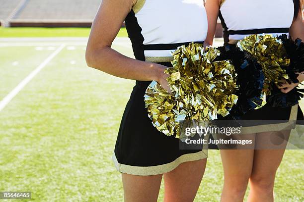 cheerleaders holding pom poms - white pom pom stock pictures, royalty-free photos & images