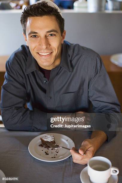 man eating slice of chocolate cake - chocolate souffle stock pictures, royalty-free photos & images