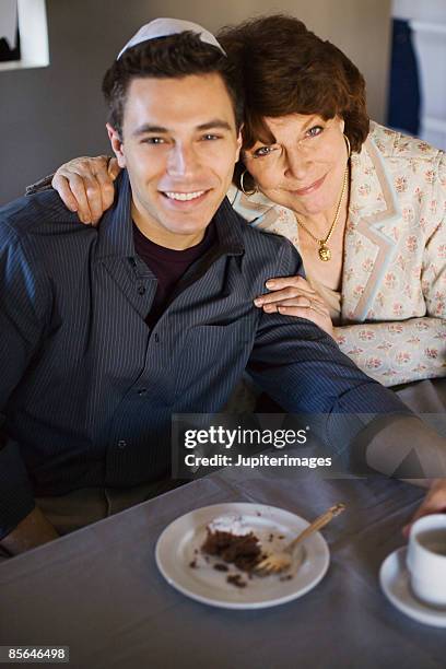 mother and son sitting in front of slice of chocolate cake - chocolate souffle stock pictures, royalty-free photos & images
