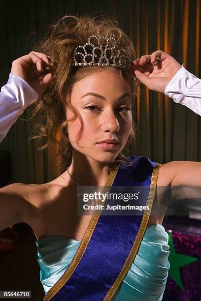 prom queen adjusting crown - winner sash stock pictures, royalty-free photos & images