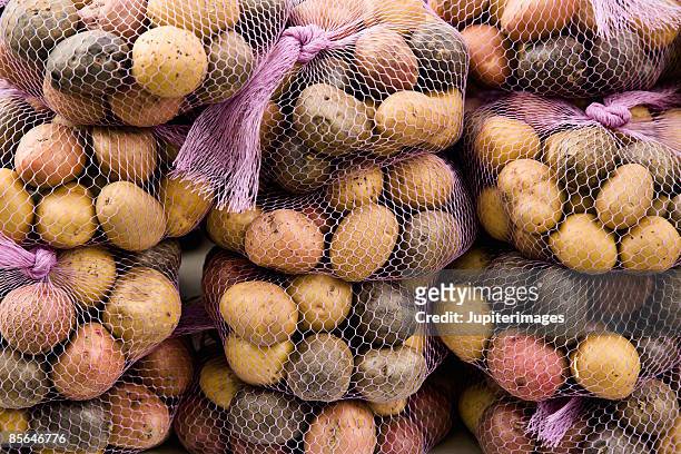 bags of assorted potatoes - raw new potato stock pictures, royalty-free photos & images