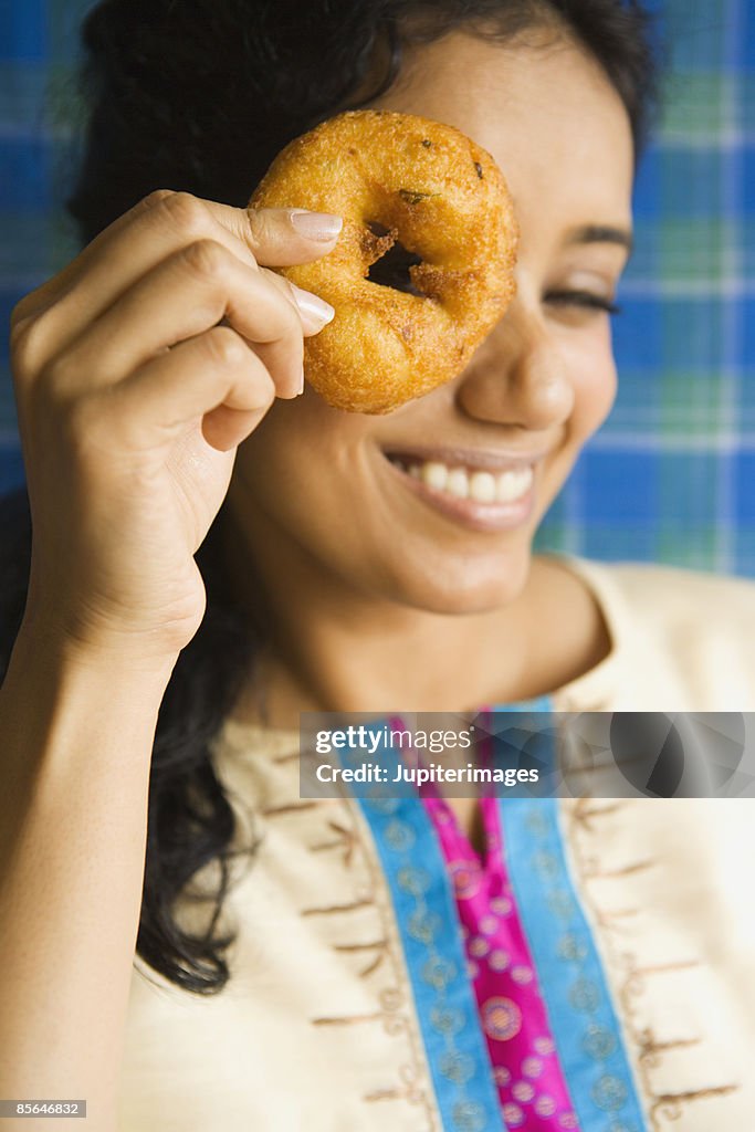 Woman looking through medu vada