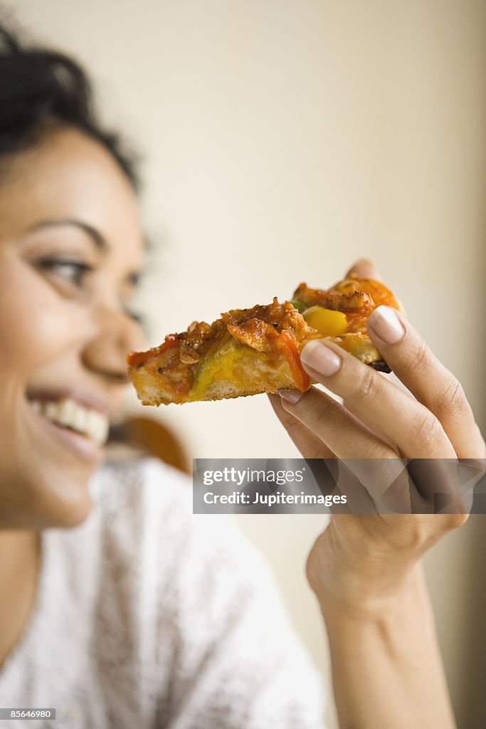 Woman with slice of pizza