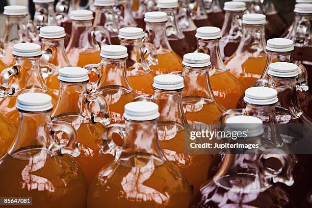 jugs of fresh apple juice at farmer's market - apple juice stock pictures, royalty-free photos & images