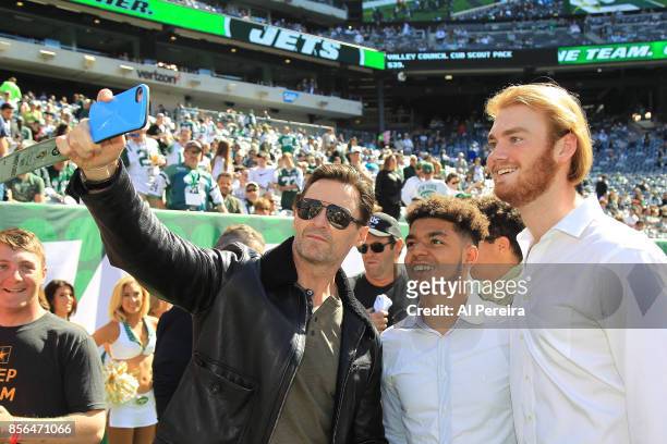 Hugh Jackman poses for selphies with fans on the sideline when he attends the Jacksonville Jaguars vs New York Jets game at MetLife Stadium on...