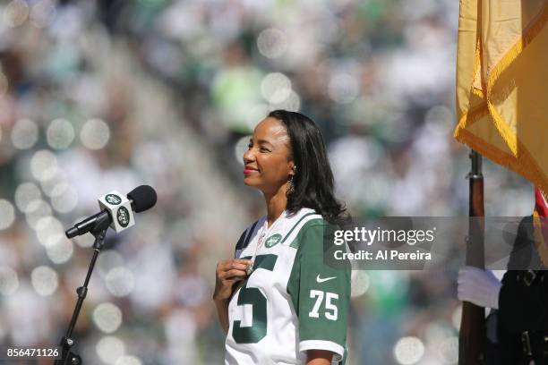 Heather Hill touches her late father Winston Hill's New York Jets Super Bowl III championship ring when she performs the National Anthem before the...