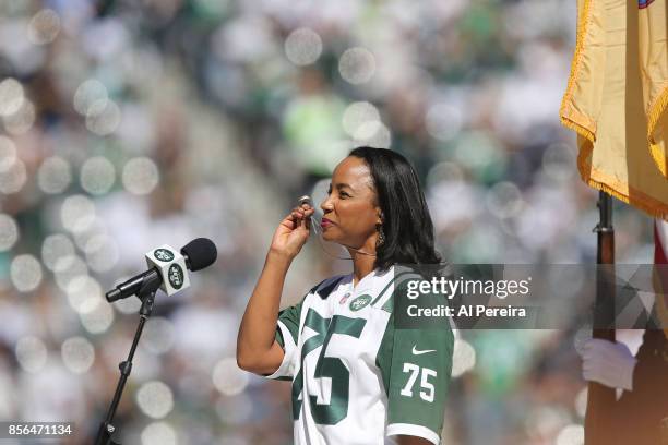 Heather Hill touches her late father Winston Hill's New York Jets Super Bowl III championship ring when she performs the National Anthem before the...