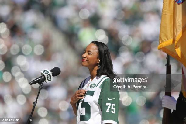 Heather Hill touches her late father Winston Hill's New York Jets Super Bowl III championship ring when she performs the National Anthem before the...