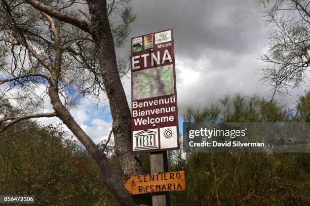 Sign welcomes visitors to a hiking trail on the northern slope of Mt. Etna volcano, Europe's largest and most active, on September 21, 2017 in...