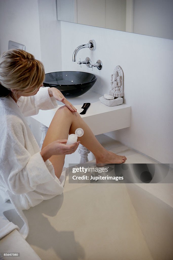Woman shaving her legs