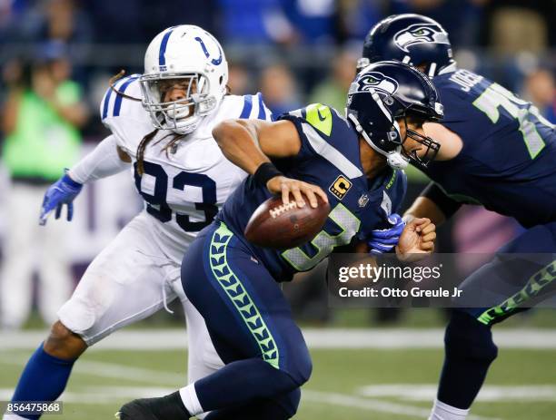 Quarterback Russell Wilson of the Seattle Seahawks rushes past Jabaal Sheard of the Indianapolis Colts in the fourth quarter of the game at...