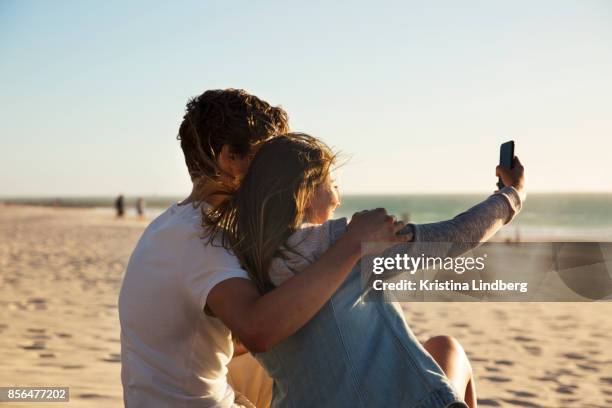 couple by the beach at sun set - beach selfie bildbanksfoton och bilder