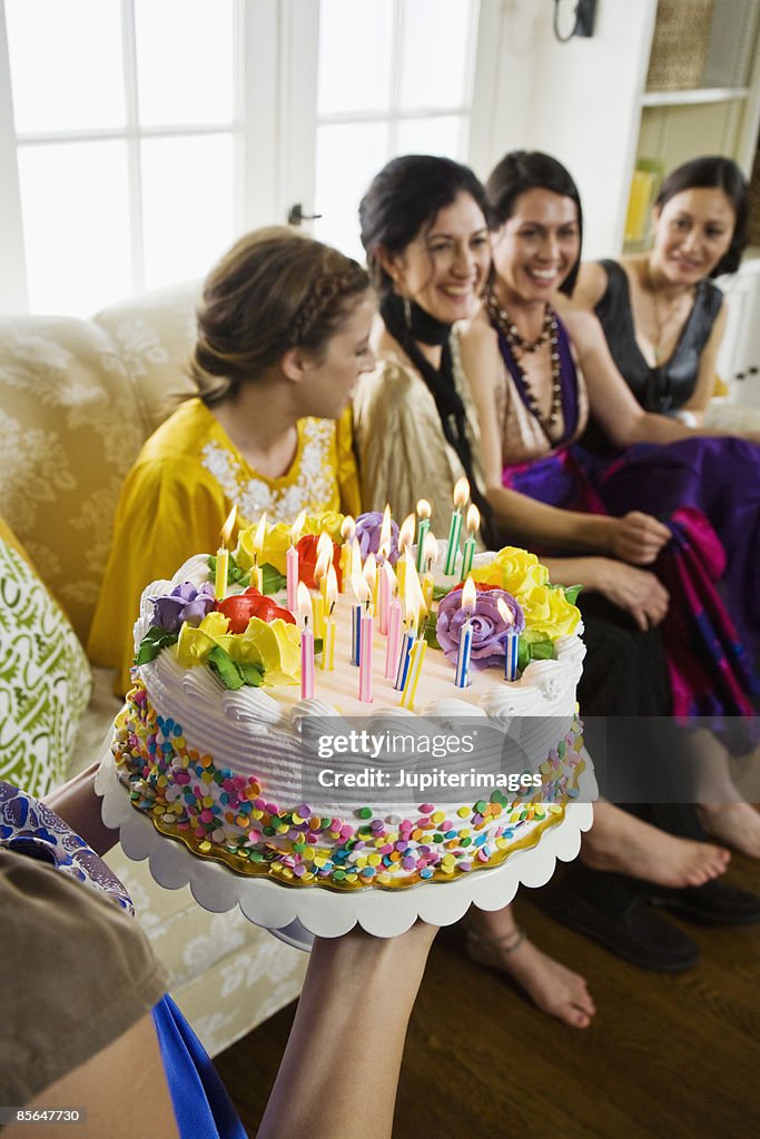 Smiling women with birthday cake