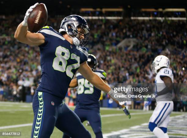 Tight end Luke Willson of the Seattle Seahawks spikes the ball as he celebrates his touchdown against the Indianapolis Colts in the fourth quarter of...