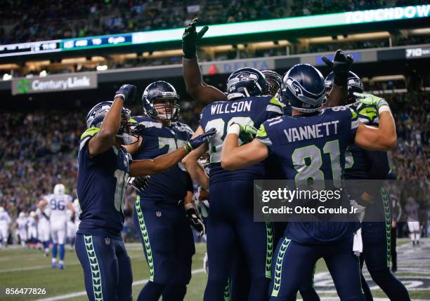 Tight end Luke Willson of the Seattle Seahawks is mobbed by teammates after scoring a touchdown against the Indianapolis Colts in the fourth quarter...