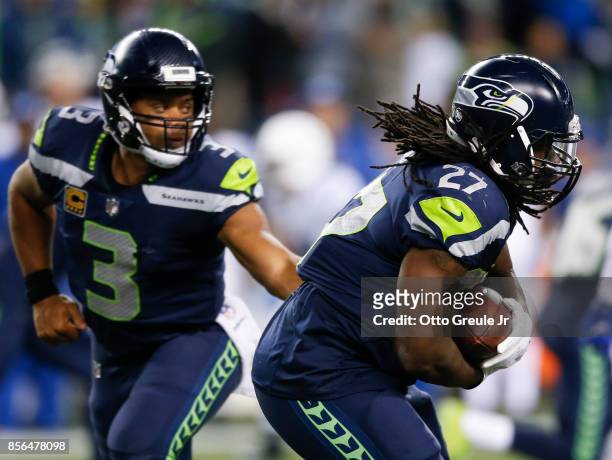 Quarterback Russell Wilson of the Seattle Seahawks hands off to running back Eddie Lacy of the Seattle Seahawks in the fourth quarter of the game at...