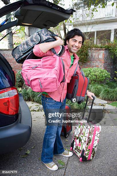 Man Putting Luggage In Car Photos and Premium High Res Pictures - Getty ...