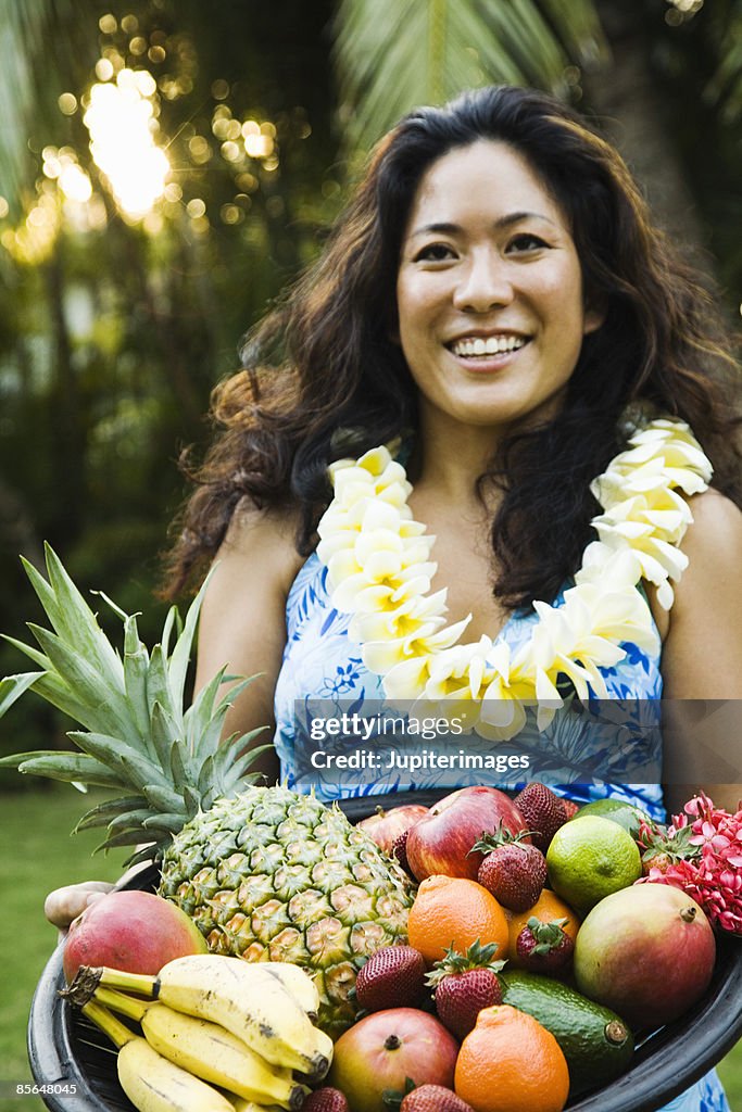 Woman holding platter of fruit