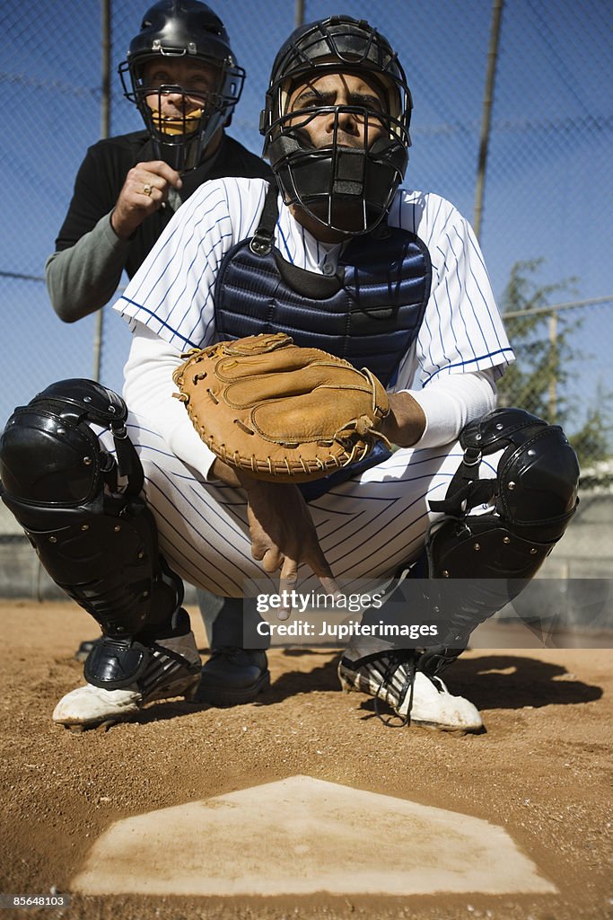 Baseball catcher and umpire behind home plate