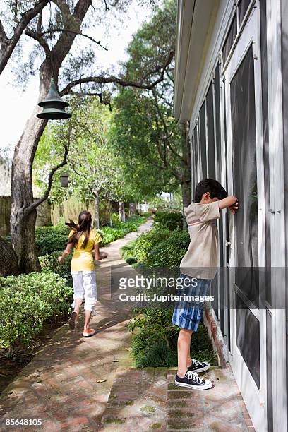 children playing hide-and-seek - hide and seek stock pictures, royalty-free photos & images
