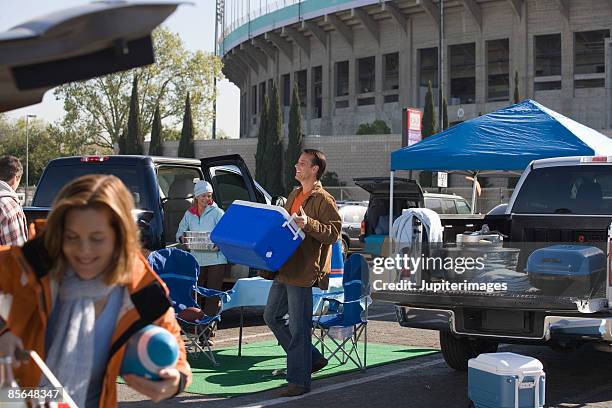 man with cooler at tailgate party - piquenique na traseira do carro imagens e fotografias de stock