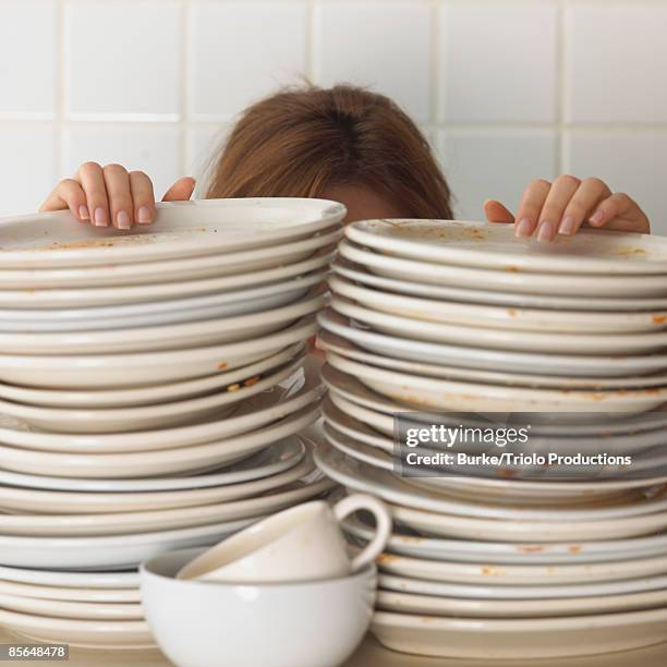 woman with stacked dishes - washing dishes bildbanksfoton och bilder