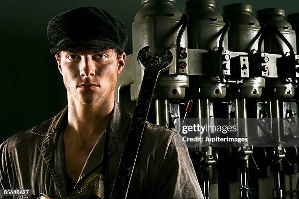 proletariat worker holding wrench - socialismo foto e immagini stock