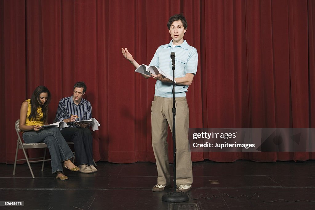 Man speaking in front of microphone