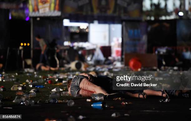 Person lies on the ground covered with blood at the Route 91 Harvest country music festival after apparent gun fire was heard on October 1, 2017 in...