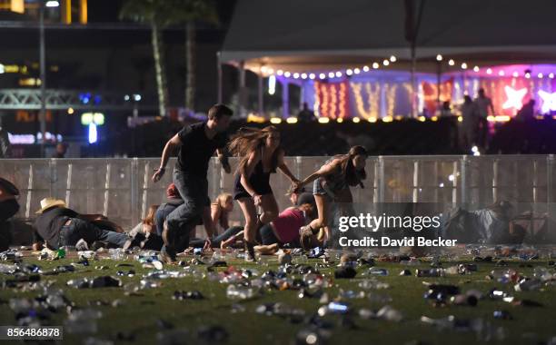 People run from the Route 91 Harvest country music festival after apparent gun fire was heard on October 1, 2017 in Las Vegas, Nevada. There are...