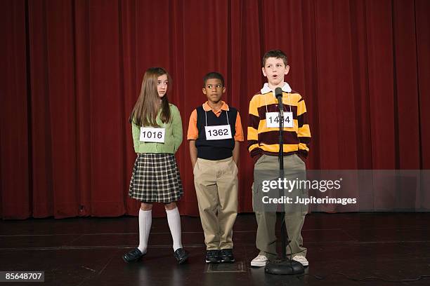 spelling bee participants on stage - orthographic symbol stock pictures, royalty-free photos & images