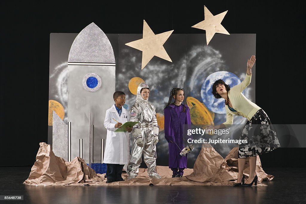 Teacher working with students dressed in costumes