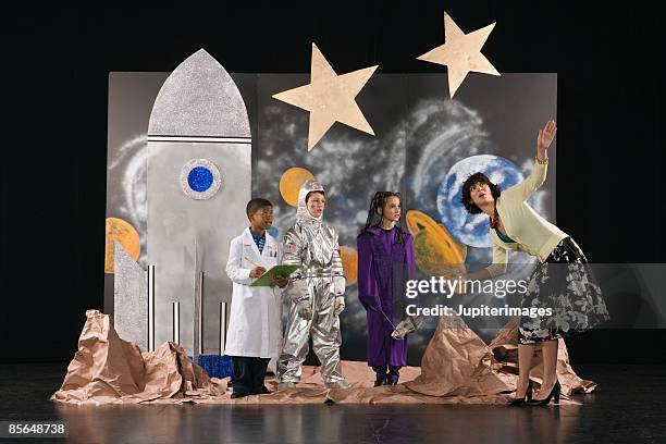 teacher working with students dressed in costumes - peça de teatro escolar imagens e fotografias de stock