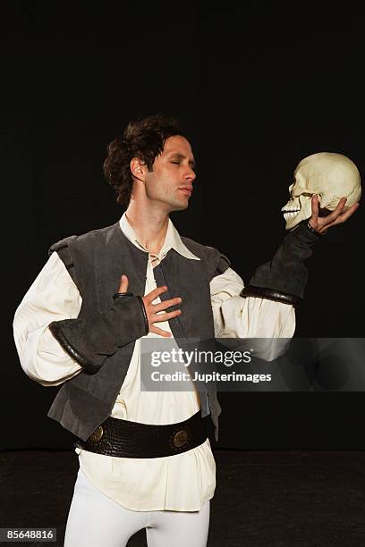 man holding skull - dramatic actor stock pictures, royalty-free photos & images