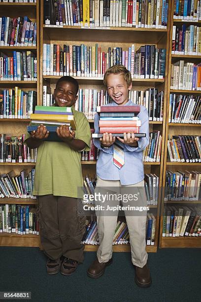 boys holding stacks of books - school tie stock pictures, royalty-free photos & images