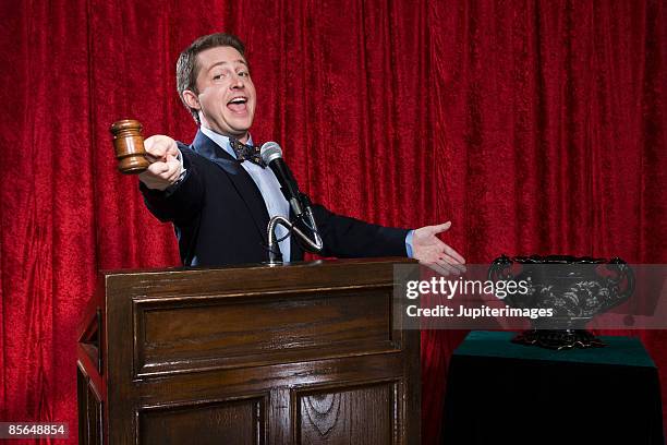 auctioneer with urn - auction fotografías e imágenes de stock