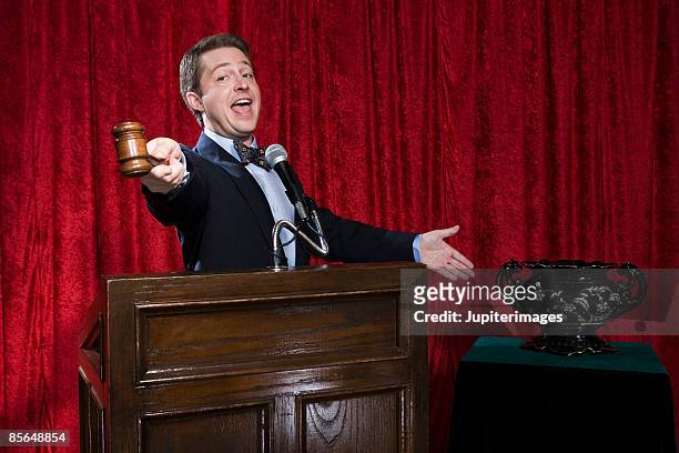 auctioneer with urn - auction stock pictures, royalty-free photos & images