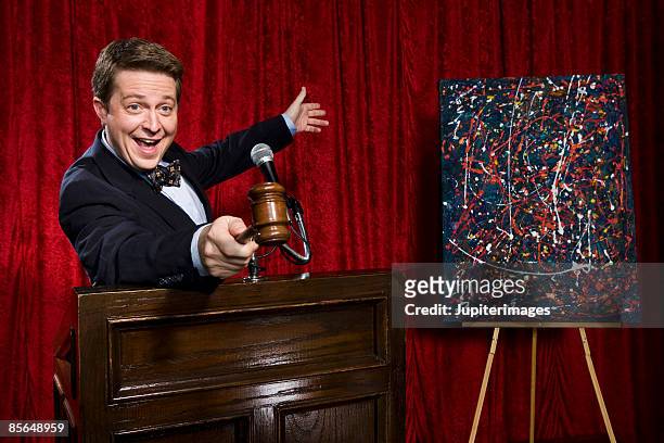 auctioneer gesturing - auctioneer stock pictures, royalty-free photos & images