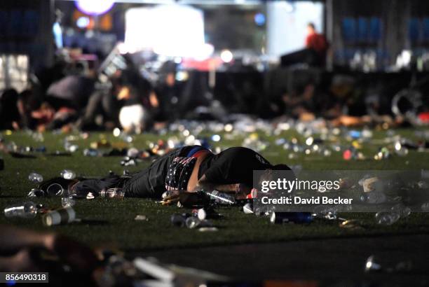 Person lies on the ground at the Route 91 Harvest country music festival after apparent gun fire was heard on October 1, 2017 in Las Vegas, Nevada....