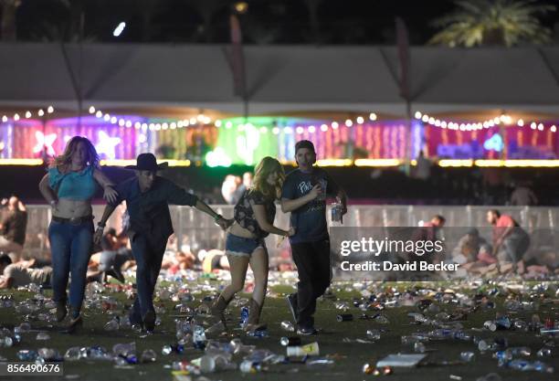 People run from the Route 91 Harvest country music festival after apparent gun fire was heard on October 1, 2017 in Las Vegas, Nevada. There are...