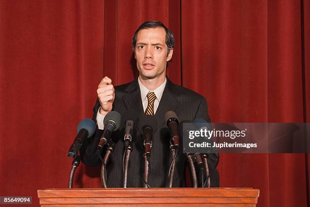 expressive man behind podium - election candidate stock pictures, royalty-free photos & images