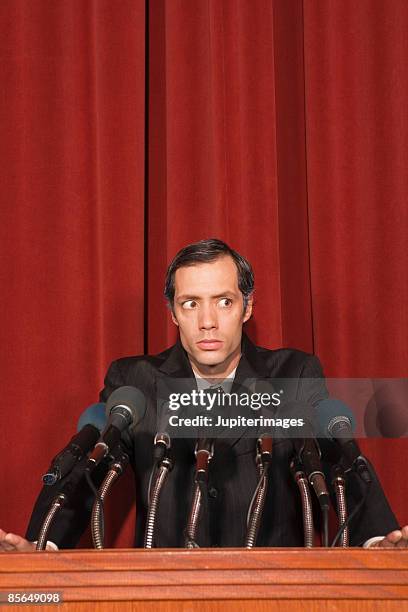 man standing at podium - evasive stock pictures, royalty-free photos & images