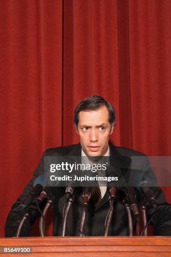 Man standing at podium Man standing at podium
