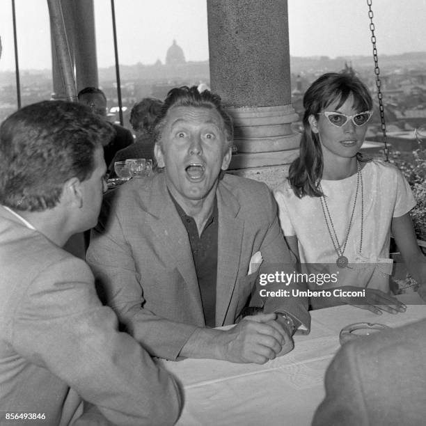 The actor Kirk Douglas is with the actress and model Elsa Martinelli at 'Casina Valadier' in Rome, 1958. He is making a funny expression in this...