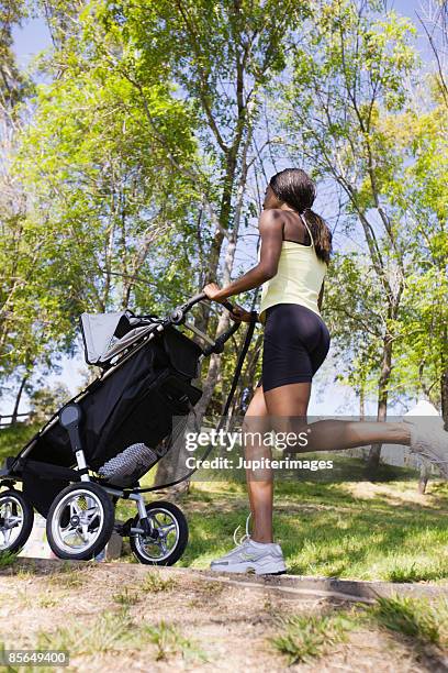 woman jogging with stroller - three wheeled pushchair stock pictures, royalty-free photos & images