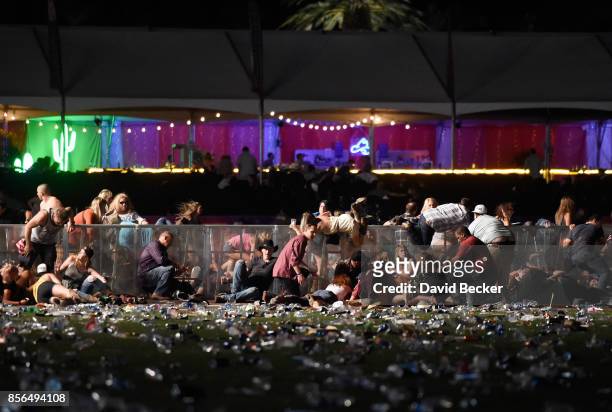 People dive for cover at Route 91 Harvest country music festival after apparent gun fire was heard on October 1, 2017 in Las Vegas, Nevada. There are...