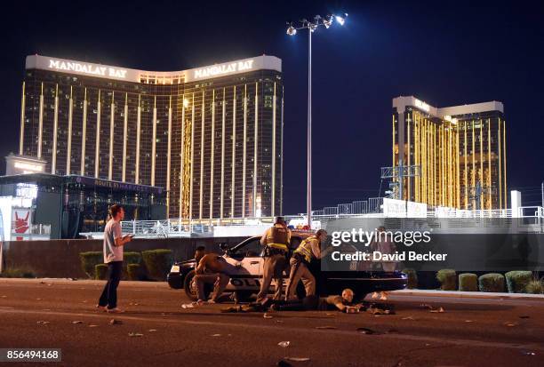 Las Vegas police stand guard along the streets outside the Route 91 Harvest Country music festival groundss of the Route 91 Harvest on October 1,...